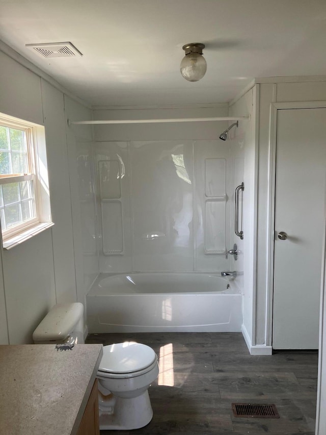 full bathroom with  shower combination, vanity, hardwood / wood-style floors, and toilet