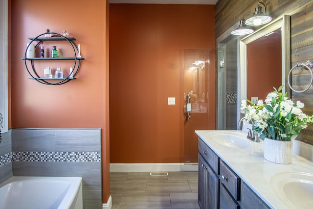 bathroom featuring vanity and a washtub