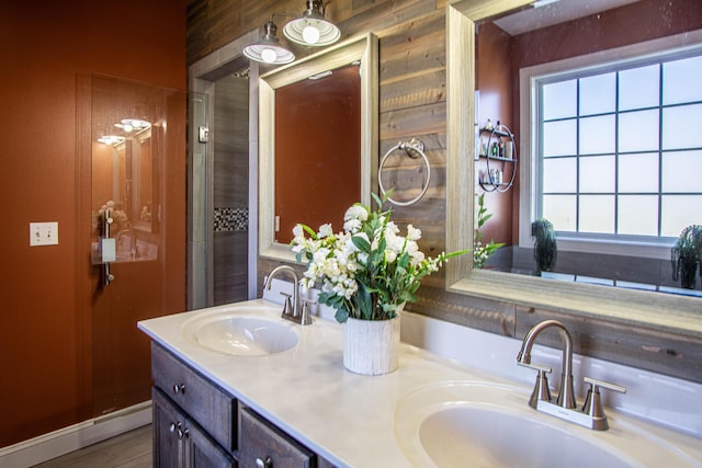 bathroom featuring wood walls and vanity