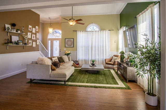 living room with hardwood / wood-style flooring, ceiling fan, and crown molding