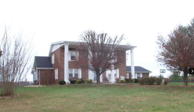 neoclassical home featuring a front yard