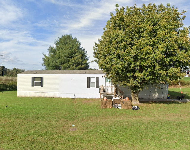 rear view of property featuring a yard