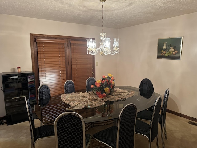 carpeted dining area with a textured ceiling, a notable chandelier, visible vents, and baseboards