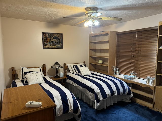 bedroom with ceiling fan and a textured ceiling