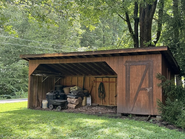 view of outbuilding featuring a forest view and an outdoor structure