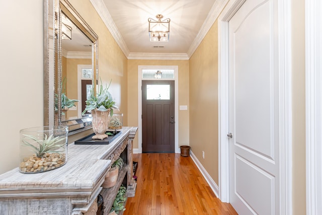 entryway with crown molding and light hardwood / wood-style flooring