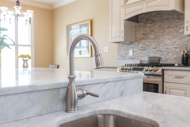 kitchen featuring stainless steel range, backsplash, premium range hood, and hanging light fixtures