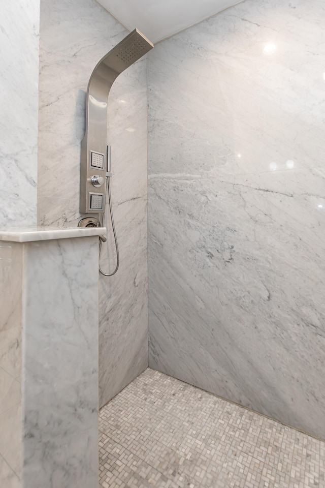 bathroom with tiled shower