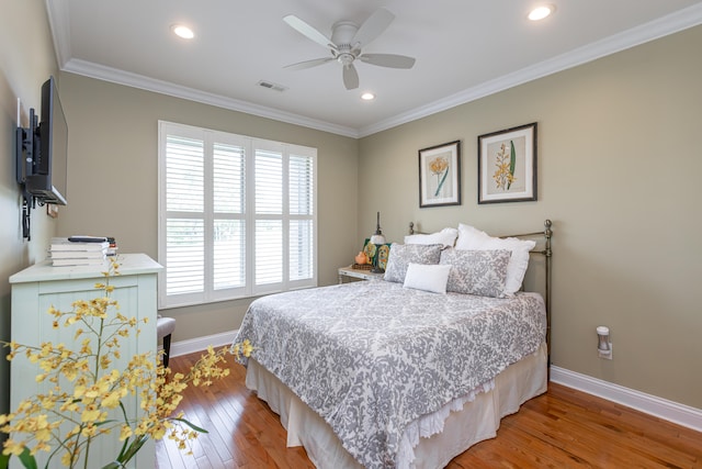 bedroom featuring crown molding, hardwood / wood-style floors, and ceiling fan