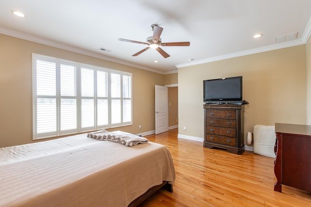 bedroom featuring ornamental molding, light hardwood / wood-style flooring, and ceiling fan