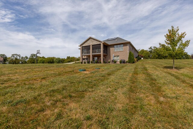 rear view of property with a lawn