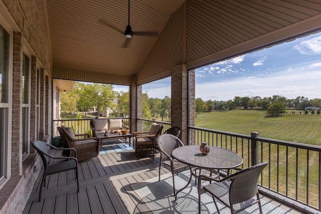 wooden terrace featuring a lawn