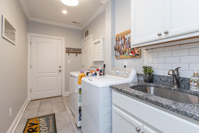 laundry room featuring cabinets, washer and clothes dryer, ornamental molding, sink, and light tile patterned flooring