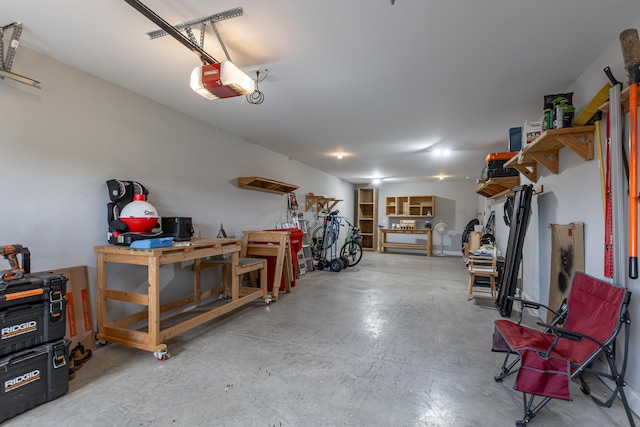 garage with a workshop area and a garage door opener