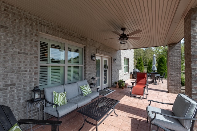 view of patio with an outdoor living space, ceiling fan, and french doors