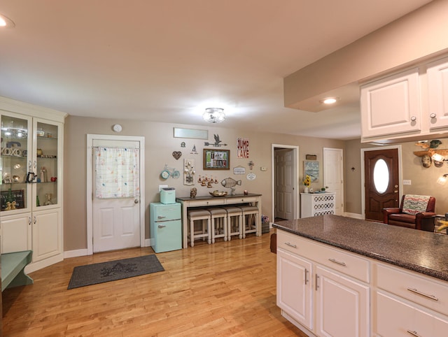 kitchen with light wood-type flooring and white cabinetry