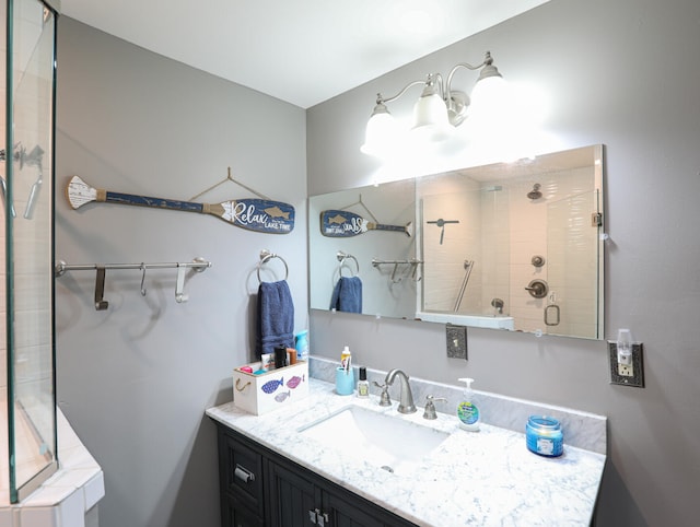 bathroom with walk in shower and vanity