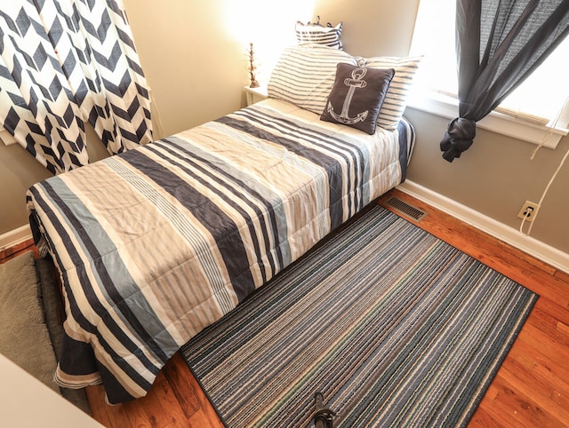 bedroom with hardwood / wood-style flooring