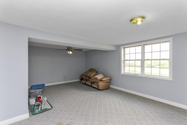 unfurnished room featuring carpet floors, baseboards, and a ceiling fan