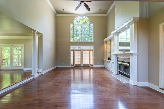 unfurnished living room with dark hardwood / wood-style floors, ceiling fan, french doors, and plenty of natural light