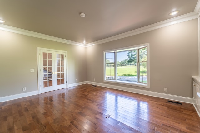 unfurnished room featuring french doors, ornamental molding, and dark hardwood / wood-style flooring