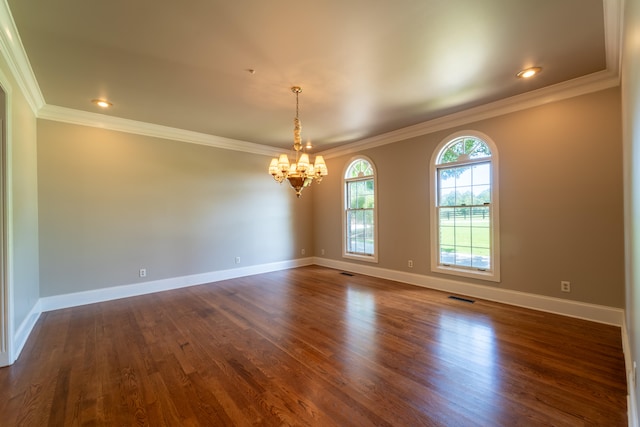 unfurnished room featuring ornamental molding, a notable chandelier, and dark wood-type flooring