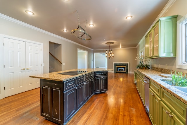 kitchen featuring wood-type flooring, a center island, hanging light fixtures, and crown molding