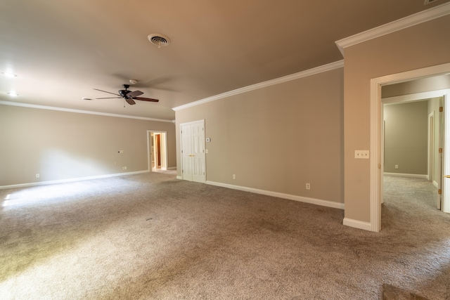 spare room featuring ceiling fan, crown molding, and carpet