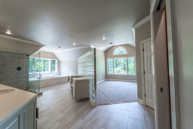 bathroom featuring lofted ceiling, independent shower and bath, vanity, and crown molding