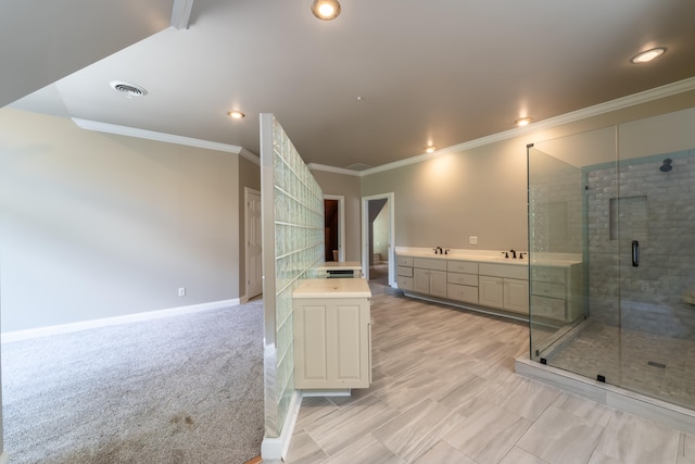 bathroom featuring vanity, ornamental molding, and a shower with door