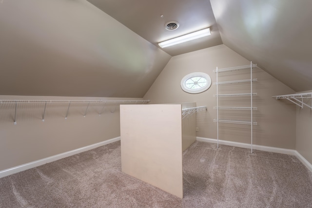 spacious closet with carpet floors and lofted ceiling