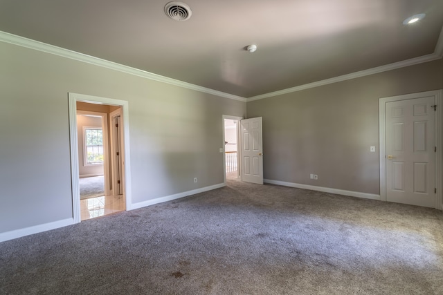 spare room featuring crown molding and carpet flooring