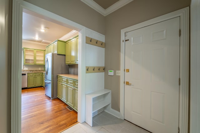 entrance foyer with light hardwood / wood-style flooring and crown molding