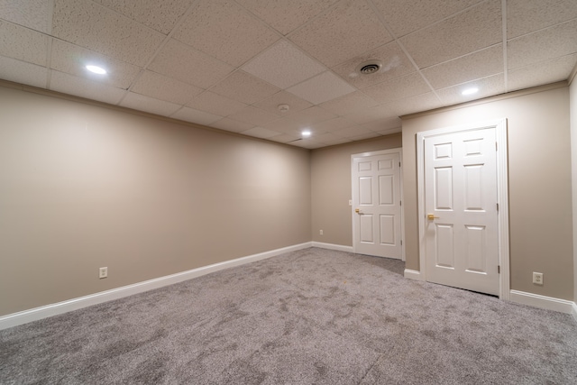 interior space with carpet floors and a paneled ceiling