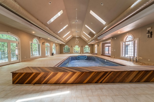 view of pool with a skylight and french doors