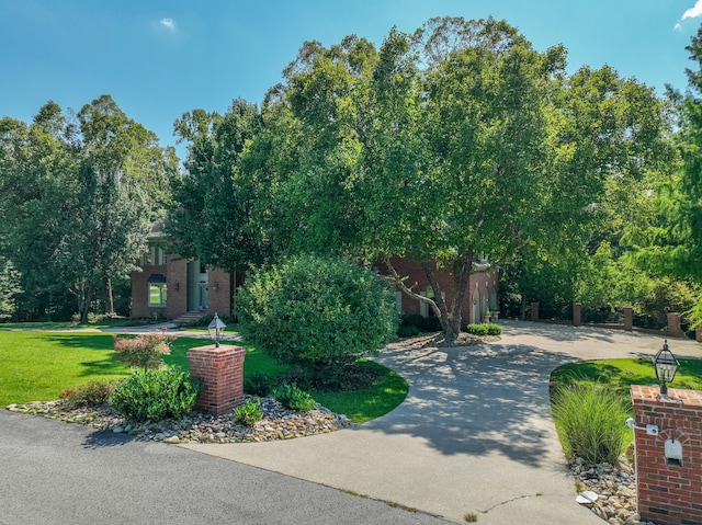 obstructed view of property featuring a front yard