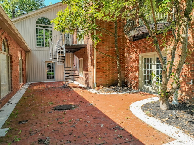 view of exterior entry featuring french doors and a patio area