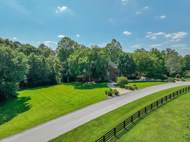 view of home's community featuring a rural view and a yard