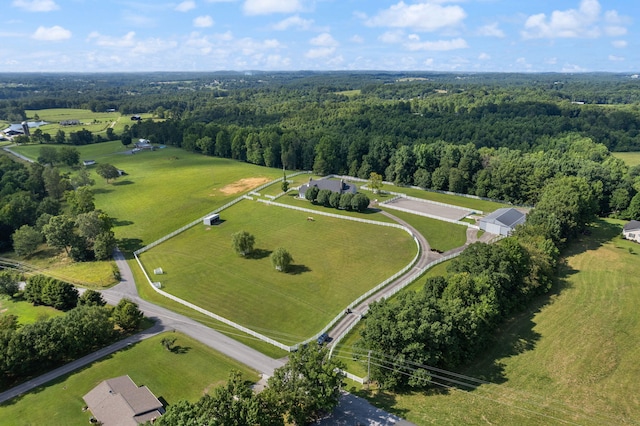 aerial view featuring a view of trees and a rural view