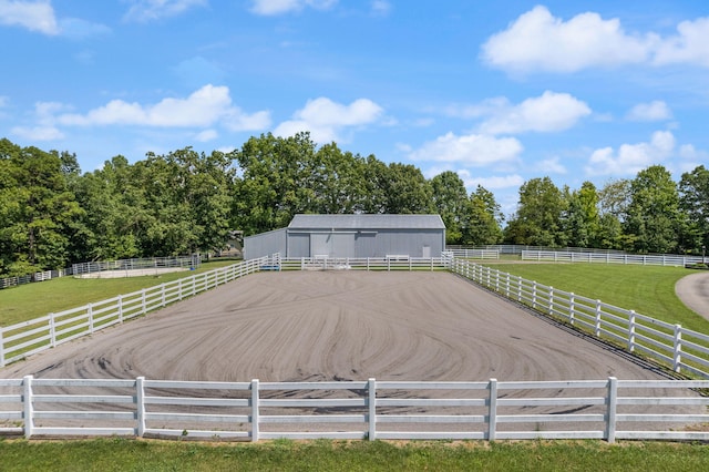 exterior space with an enclosed area, an outdoor structure, and a rural view