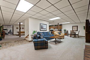 living room with a paneled ceiling