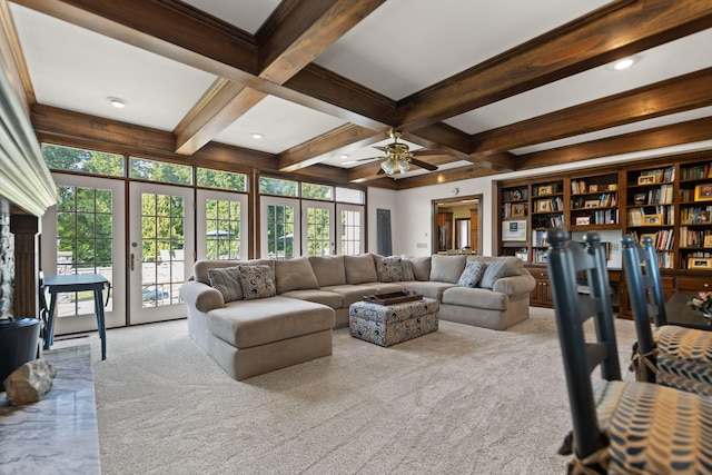 carpeted living area featuring a ceiling fan, beam ceiling, coffered ceiling, and french doors