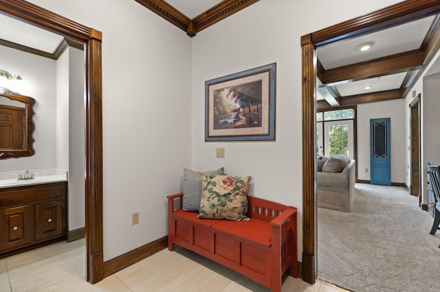 hallway with beamed ceiling, light tile patterned floors, sink, and ornamental molding