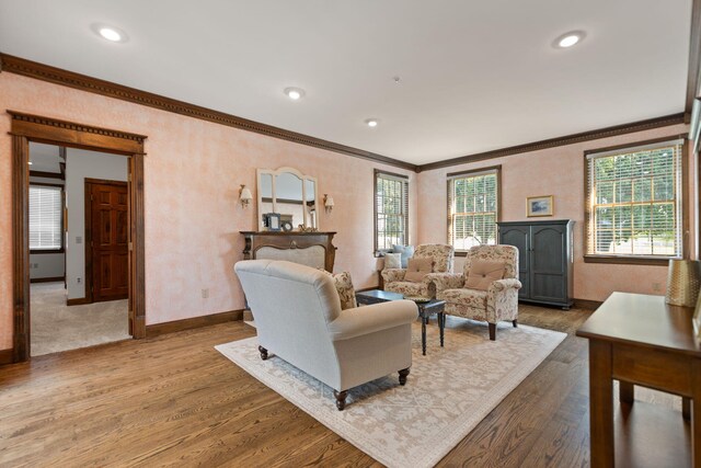 living room featuring crown molding, baseboards, wood finished floors, and recessed lighting