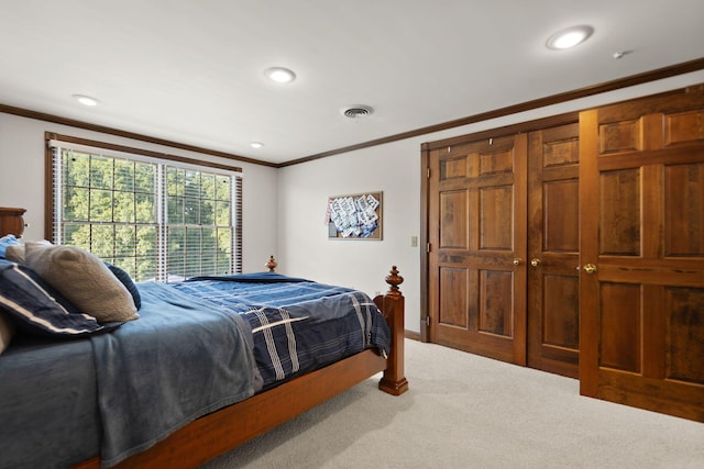 bedroom with carpet floors and crown molding