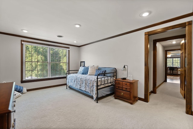 bedroom featuring light carpet, crown molding, visible vents, and baseboards