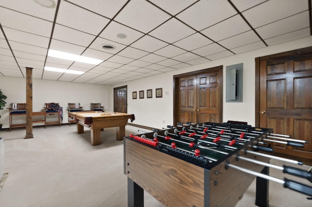 recreation room with a paneled ceiling, electric panel, visible vents, and carpet flooring