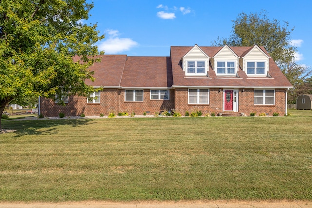 cape cod-style house featuring a front lawn