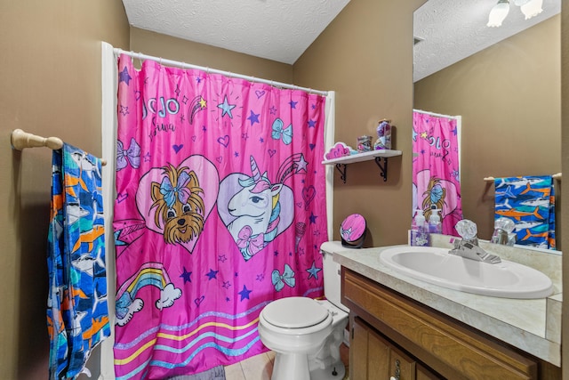 bathroom featuring vanity, tile patterned floors, a textured ceiling, and toilet