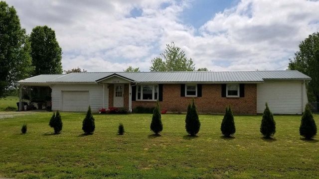 ranch-style home featuring a garage and a front lawn